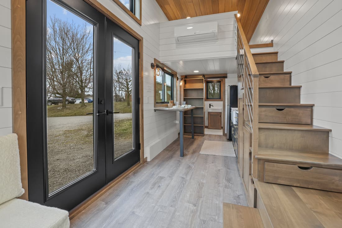 The Coastal Modern's bedroom is reached by storage-integrated staircase