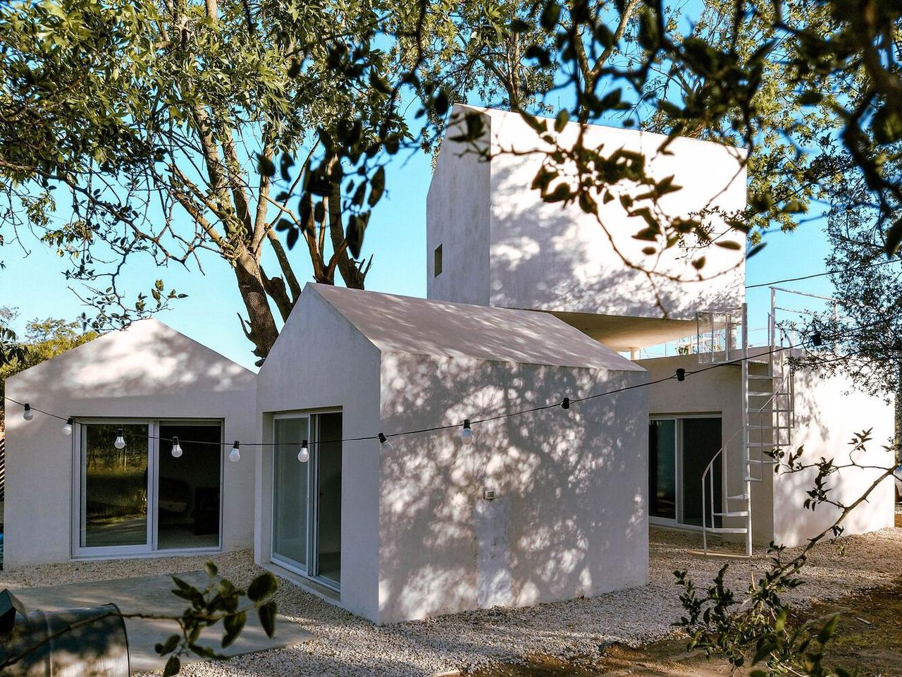 The trees are incorporated into the design in such a way that they provide a natural cooling system for the house in summer