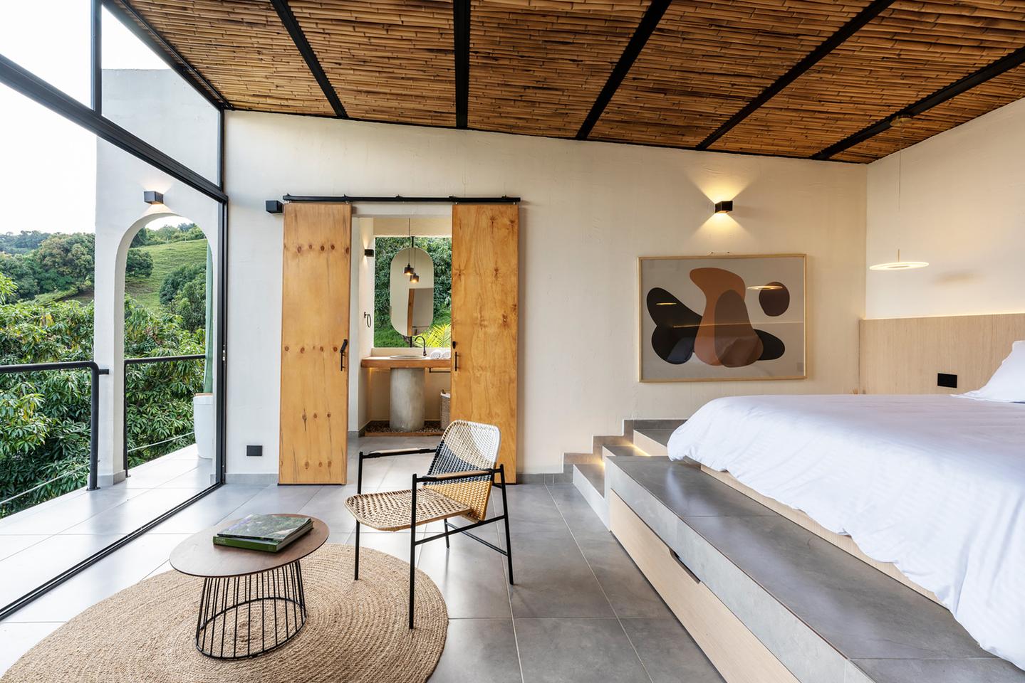 Timber sliding doors separate the bedroom from the bathroom