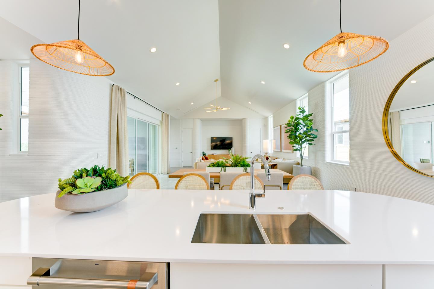 Wolf Ranch's 3D-printed model home features a large open living area with an island kitchen