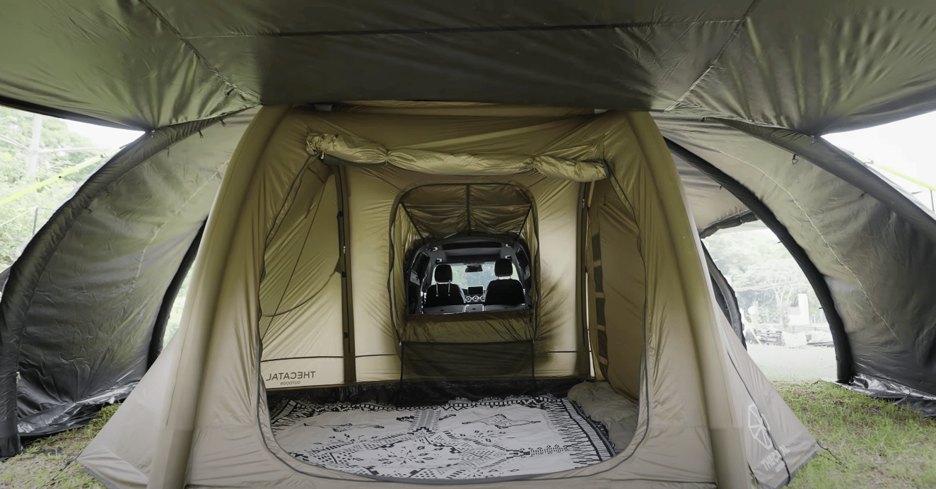 A vehicle interior inside the Smart Shell inside the Magic Fort – rooftop tent camping meets base tent camping meets in-vehicle camping