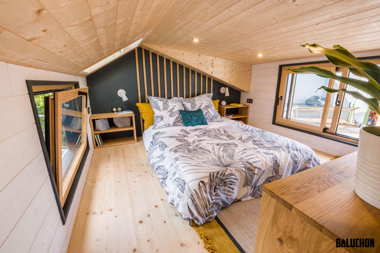 The Gaïa Tiny House's main bedroom includes a double bed and some storage space