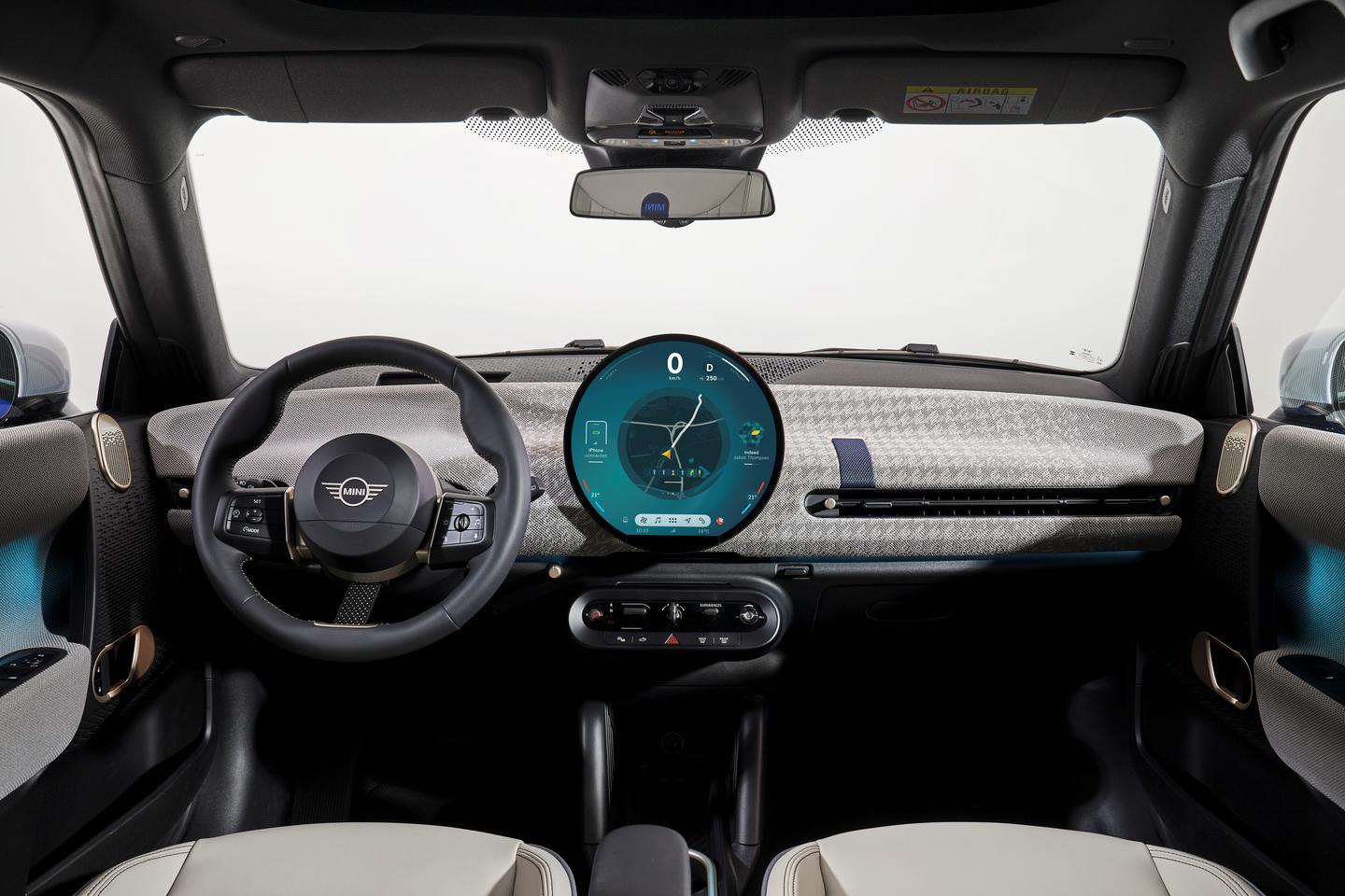 The round OLED display serves as a digital instrument cluster and entertainment hub