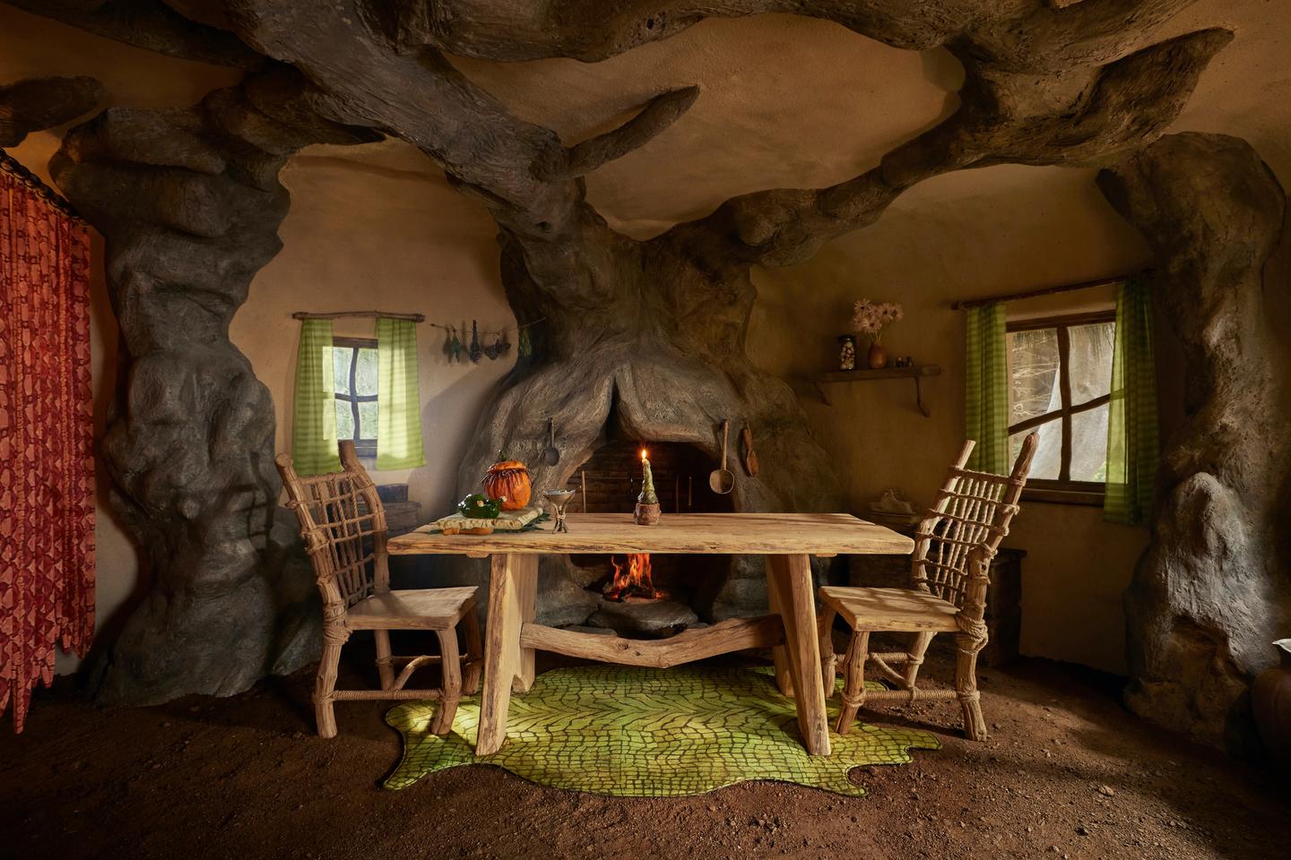 Shrek’s Swamp's interior contains a dining table and chairs, as well as a cozy fireplace