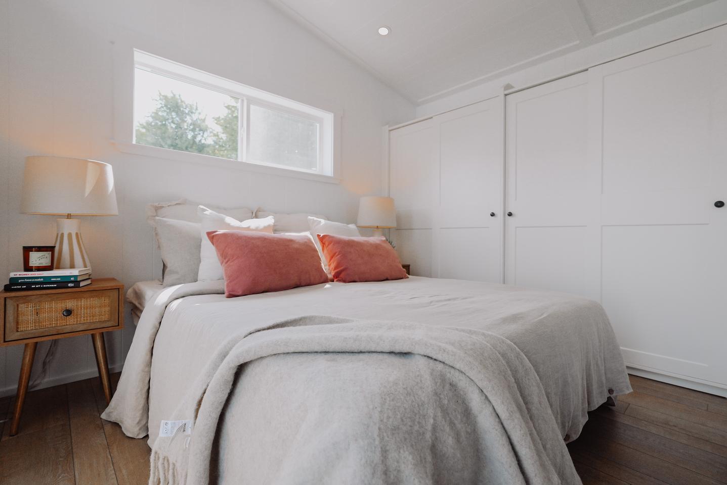 The Orca Edition Park Model's master bedroom is well-proportioned for a tiny house and includes lots of storage space