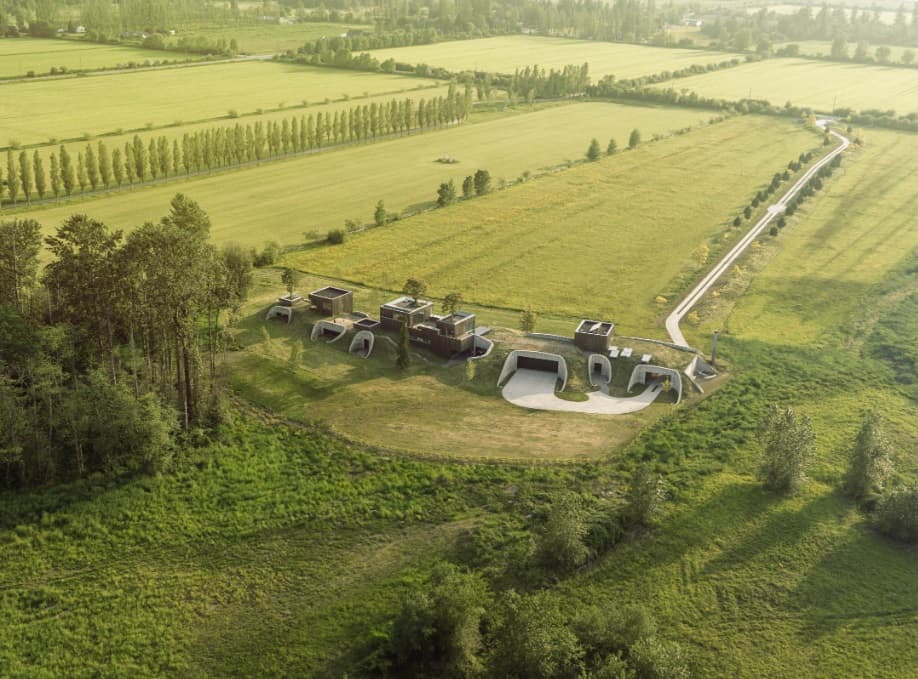 A meandering grass roof merges the home with its rural setting