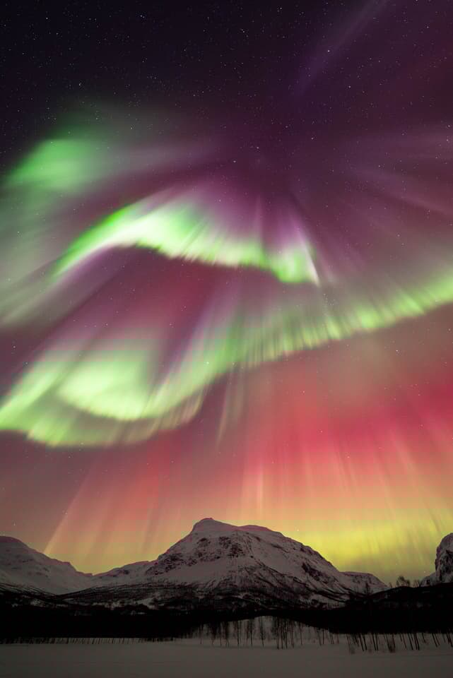 The Arctic Dance by Vincent Beudez, taken in Northern Norway. The strongest solar storm of the year, created a dancing red curtain and sharp, shimmering beams