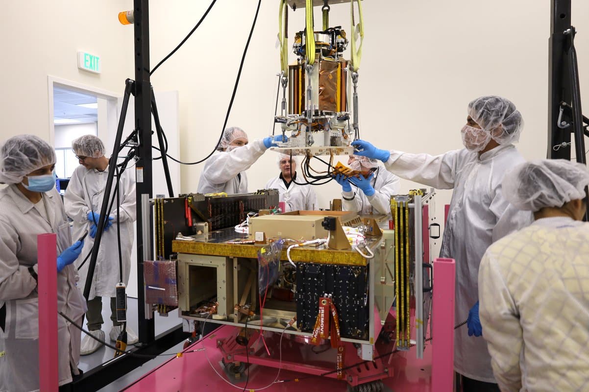 Engineers loading the DULCE portion of the SSPD onto the Momentus Vigoride spacecraft prior to launch