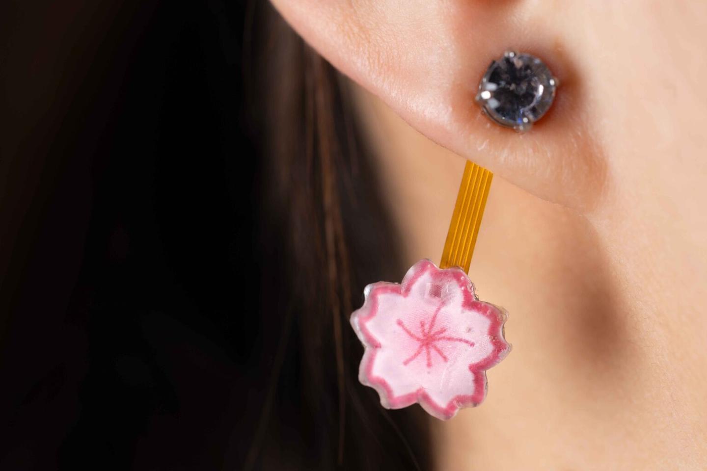 The earring can be decorated, so it doesn't look like users are wearing a mini circuit board