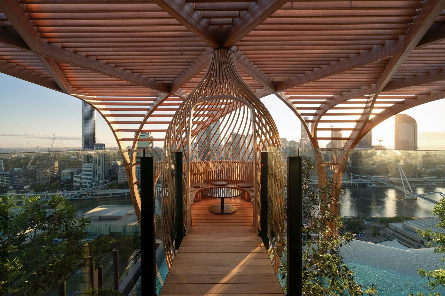 Upper House includes two timber "nest" structures that are made from 92 steam-bent ash ribs and offer a pleasant place for residents to relax