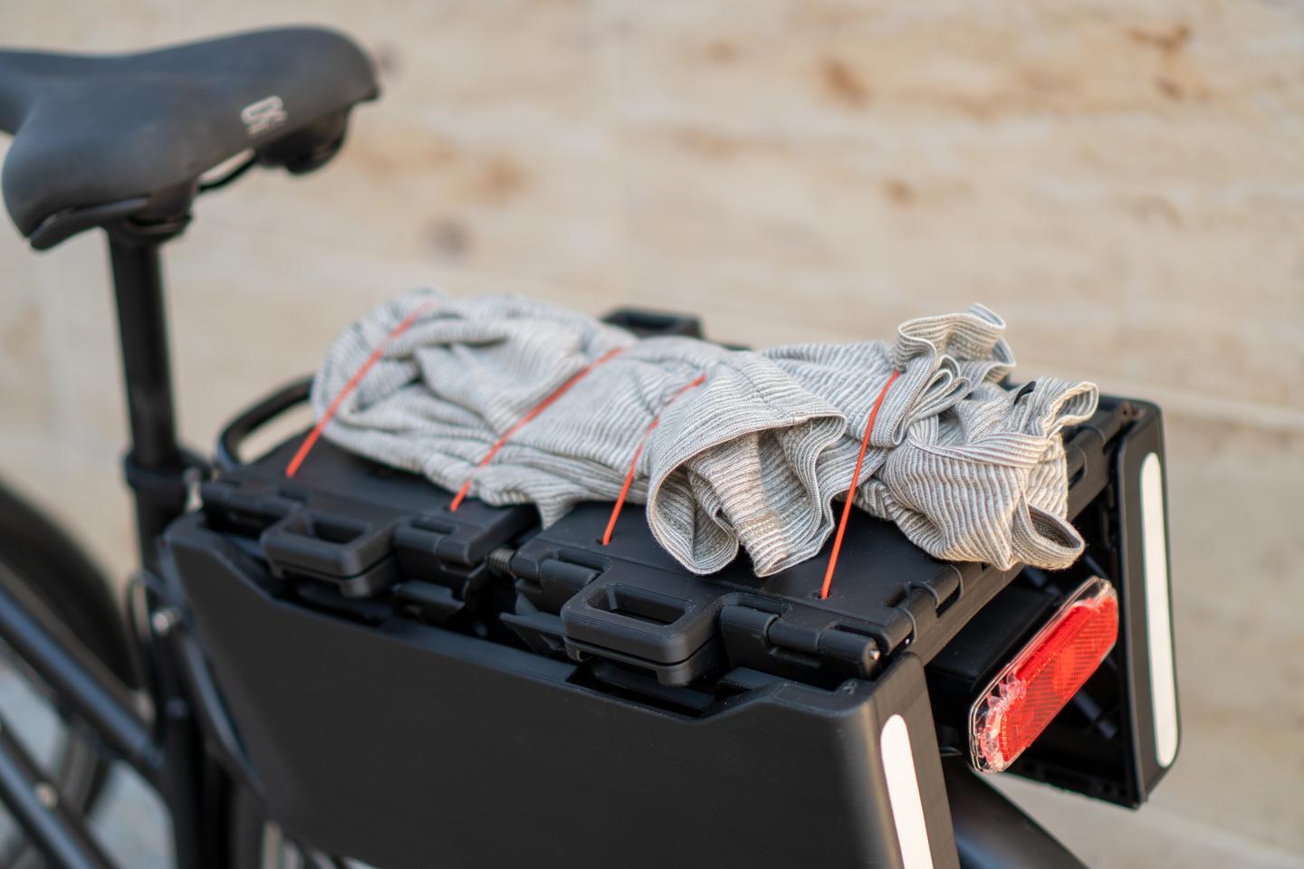 The closed Allpacka One sits flat and close to the bike, serving as a basic rack for hanging and strapping things