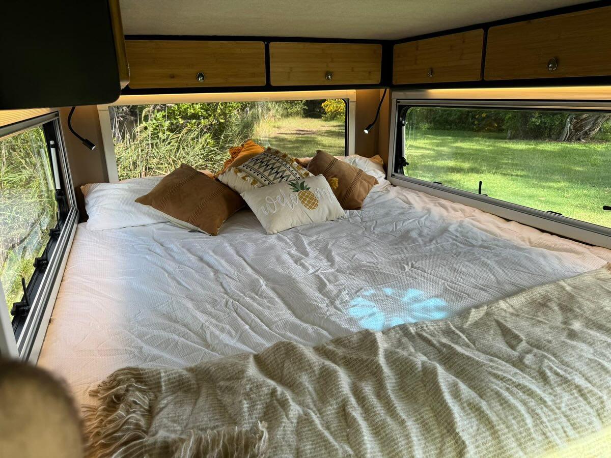 The panoramic windows bring serious light and local scenery into the king bedroom