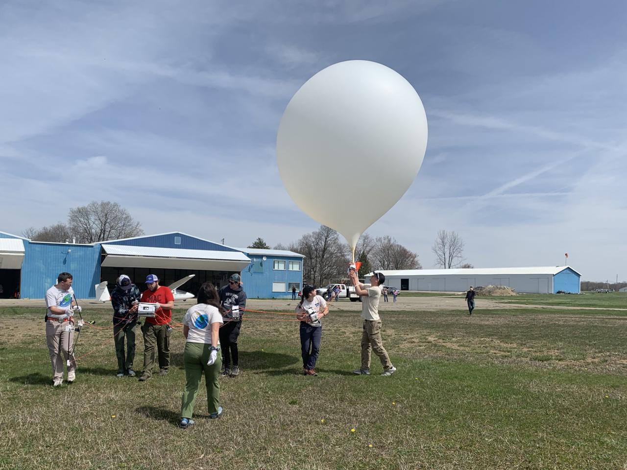 Students launch weather balloons from a location in Indiana during a solar eclipse on April 8, 2024