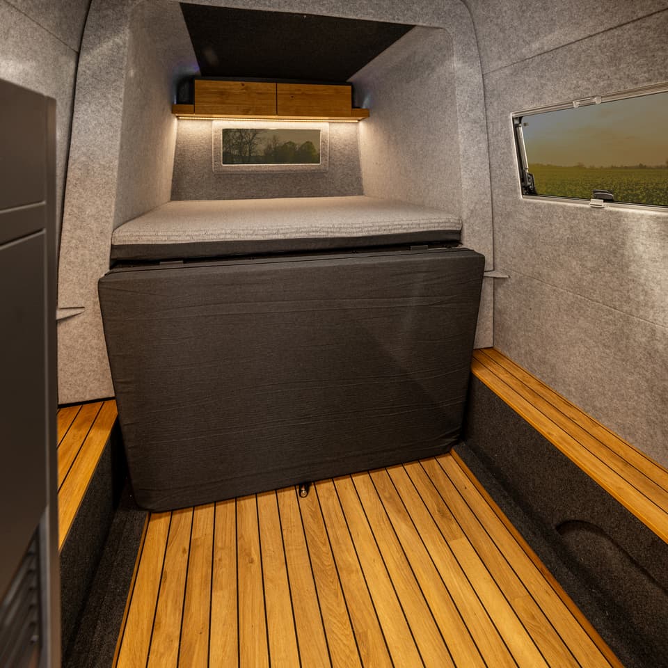There's a window to the back and lighting above the 55 x 83-inch sleeping space