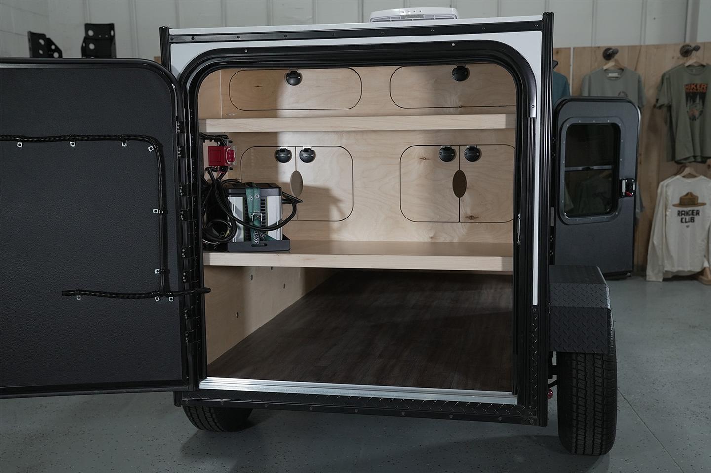The Highway Lite has a full-width rear door and a two-shelf galley with pass-through cubbies; the power station is optional