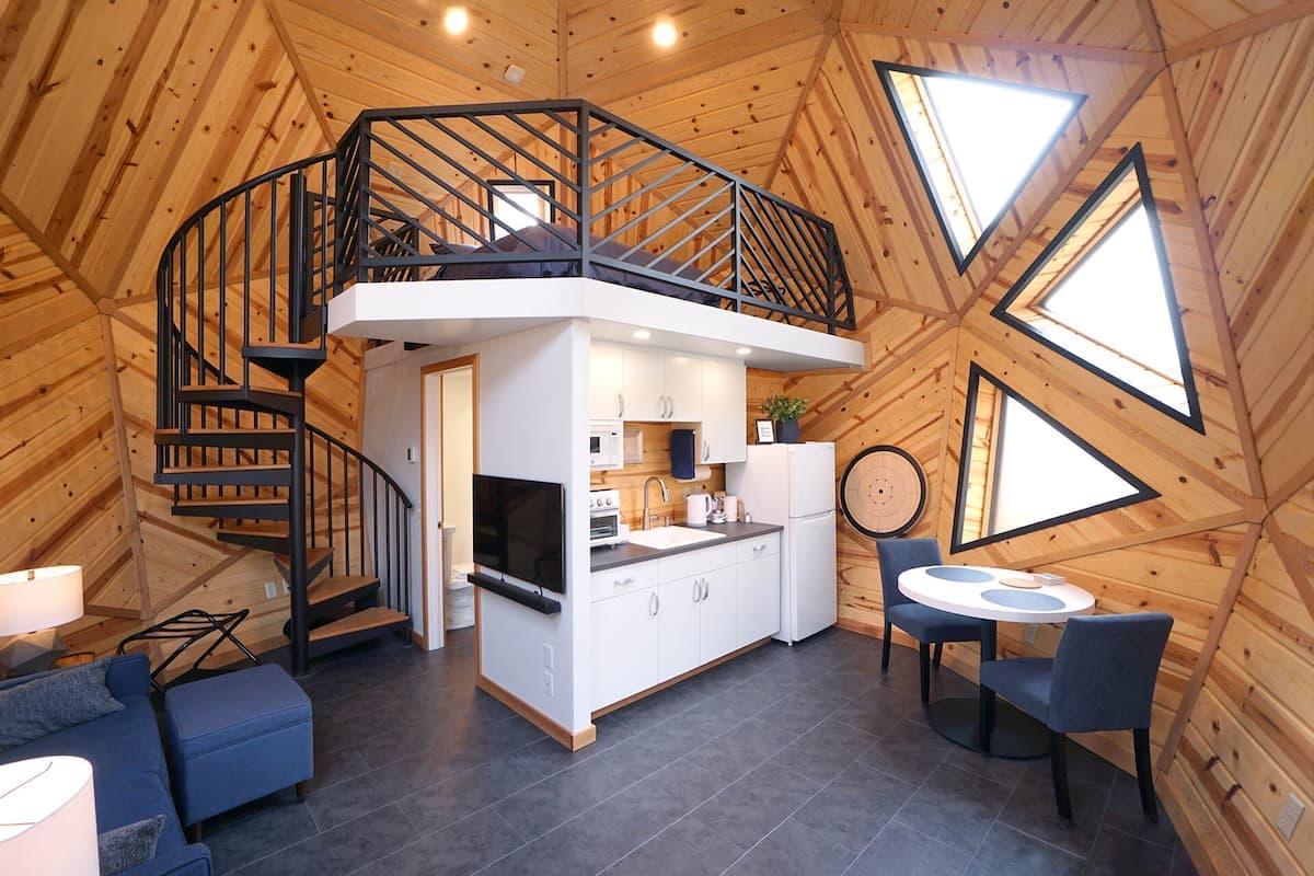 The Mini Dome's interior has a floorspace of 308 sq ft (28 sq m) and features an interesting layout centered around a large kitchen/bathroom/bedroom unit
