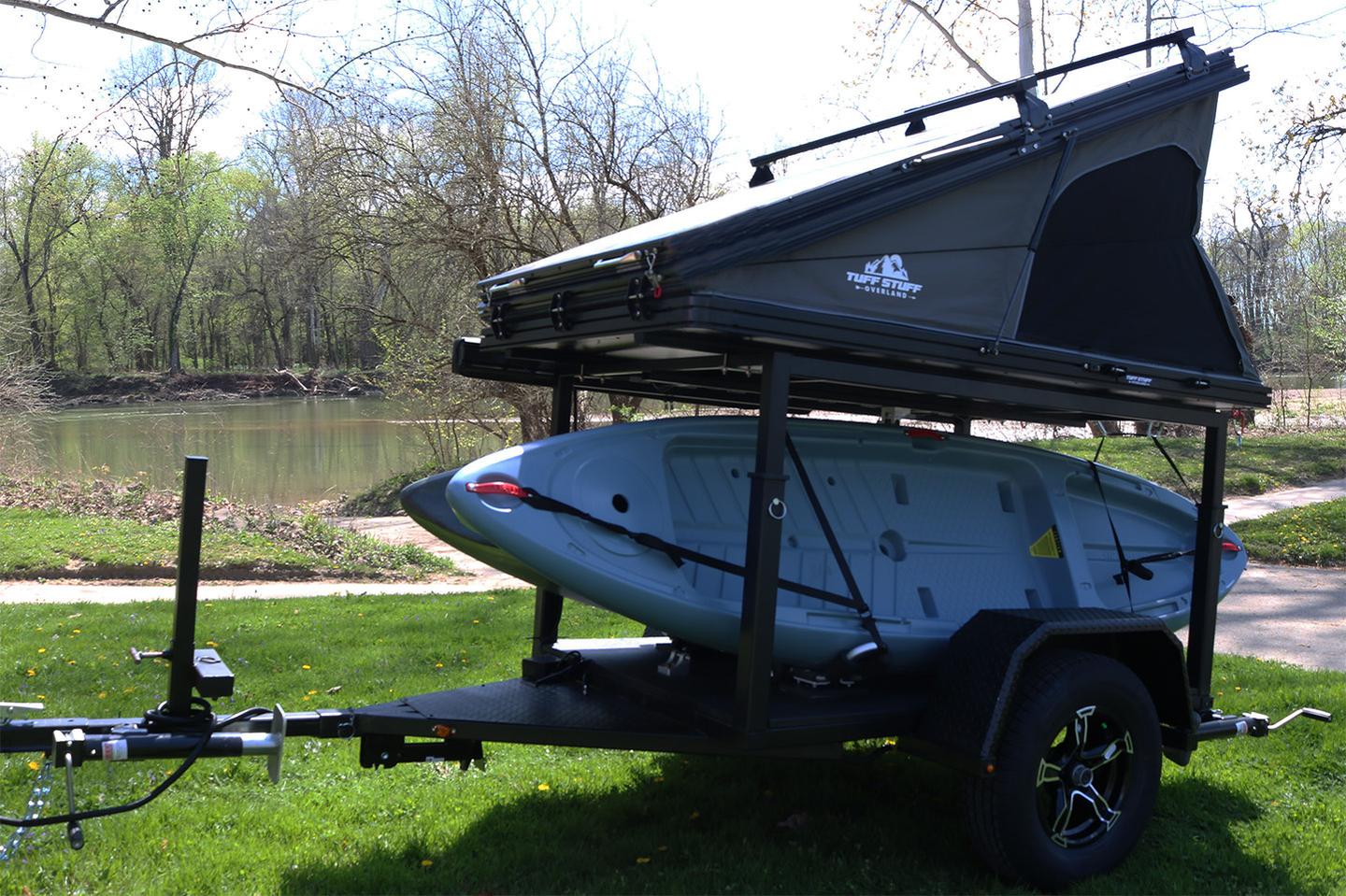 The Tuff Stuff Alpine rooftop tent shown can open halfway into wedge form or fully into more of a cube