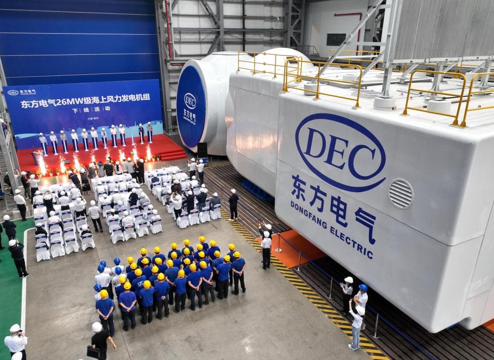 Dongfang employees celebrate as they roll out the 26 MW wind turbine nacelle