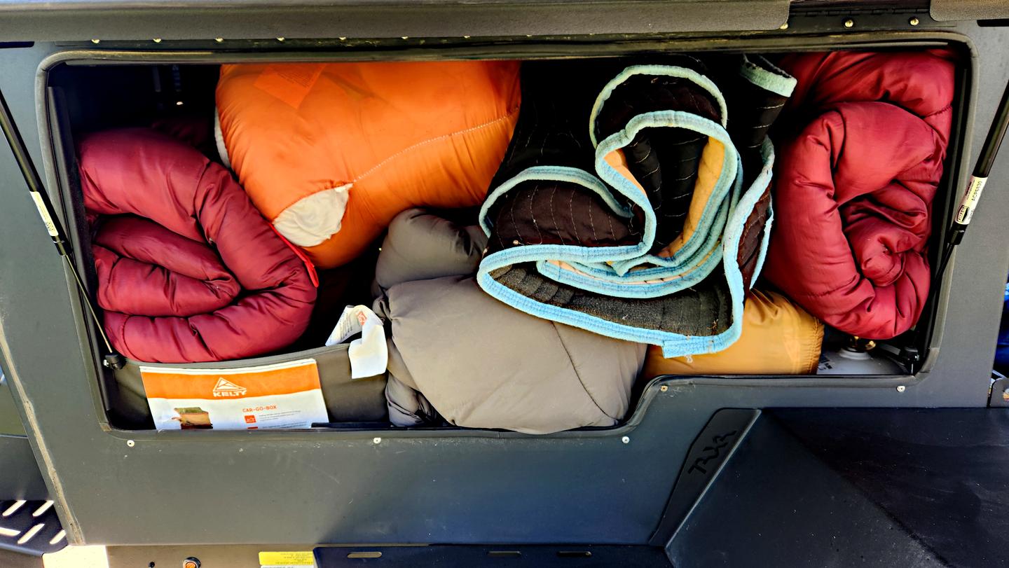 The left-side storage compartment on the Taxa Outdoors Woolly Bear Overland held five adult sleeping bags, ground covers, and more