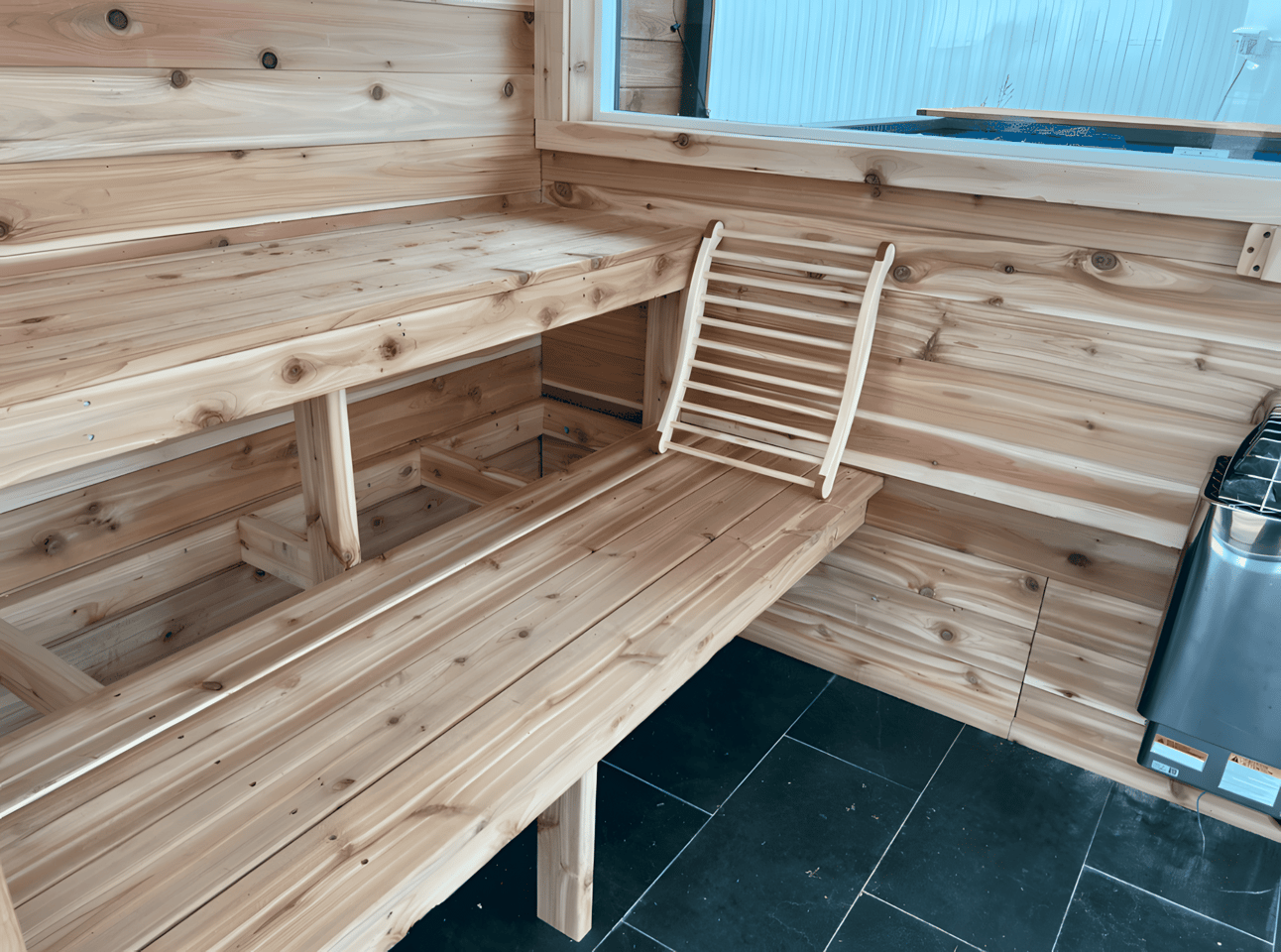 The SaunaPlunge Container's sauna area includes cedar tongue and groove walls, generous glazing, a stereo system, and an electric sauna heater