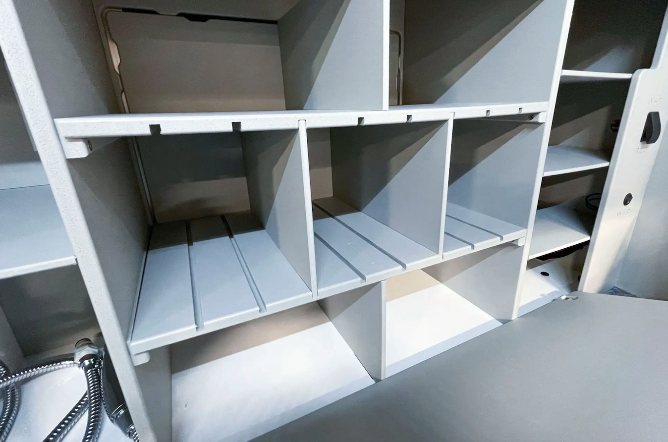 The cubby dividers behind the table-door are fully adjustable so users can set them up around their own needs