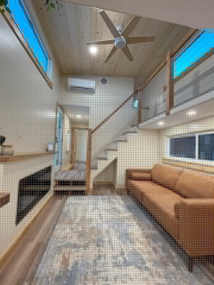 The Perpetua's living room is pictured here with a standard sofa, but a sofa bed would need to be installed to increase its sleeping capacity to eight people