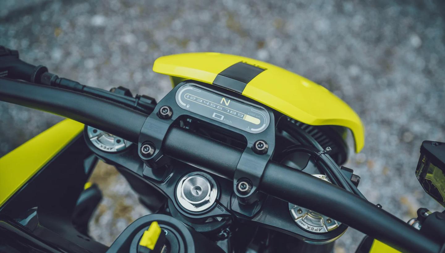 Bolted to the new handlebar, the Custom's minimalist dash is neatly hidden from view by the color-matched windshield