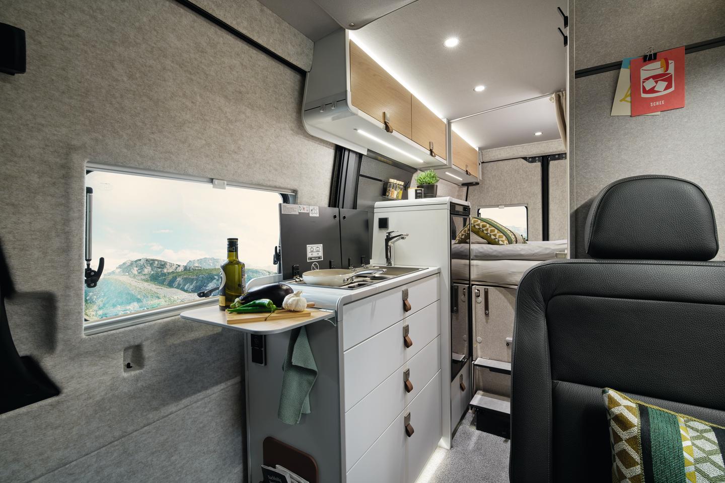 The Xperience kitchen features a combo sink/dual-burner stove, flip-up counter extension and large 90-L fridge/freezer
