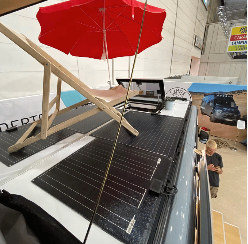 Camper Schmiede installs a rooftop terrace with walkable solar panels and a quick-access hatch from inside