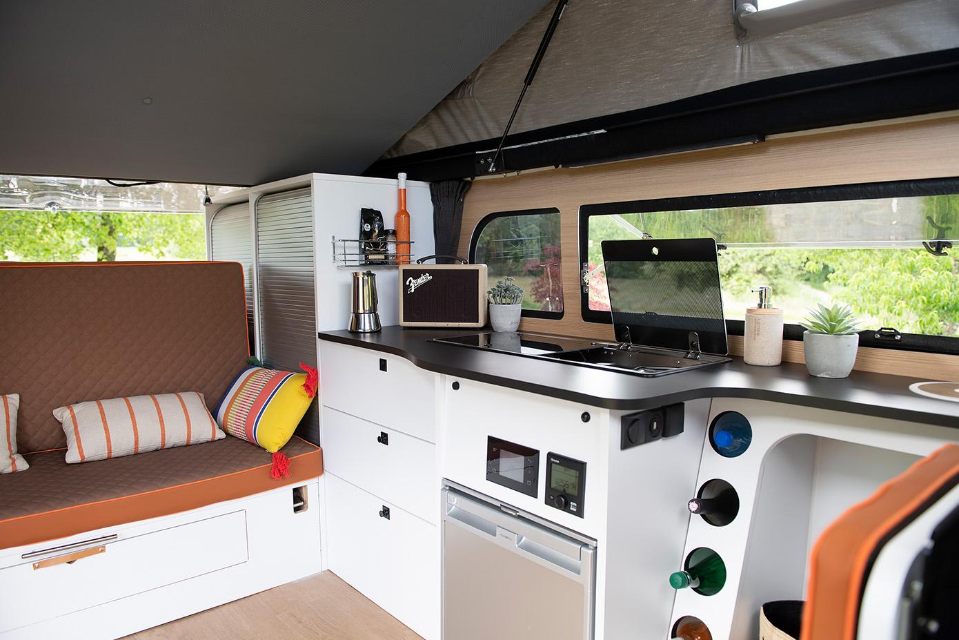 The BIvan includes a rear bench that collapses into a bed, a large kitchen block, a pop-up sleeper roof and a front bathroom