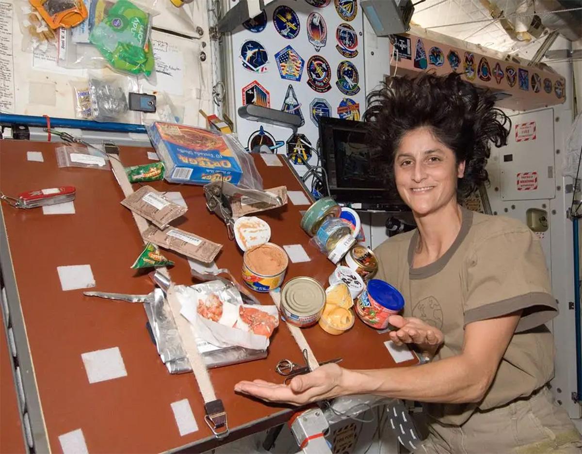 Astronaut Sunita Williams displays the meal she prepared in the ISS' Unity Node 1 module