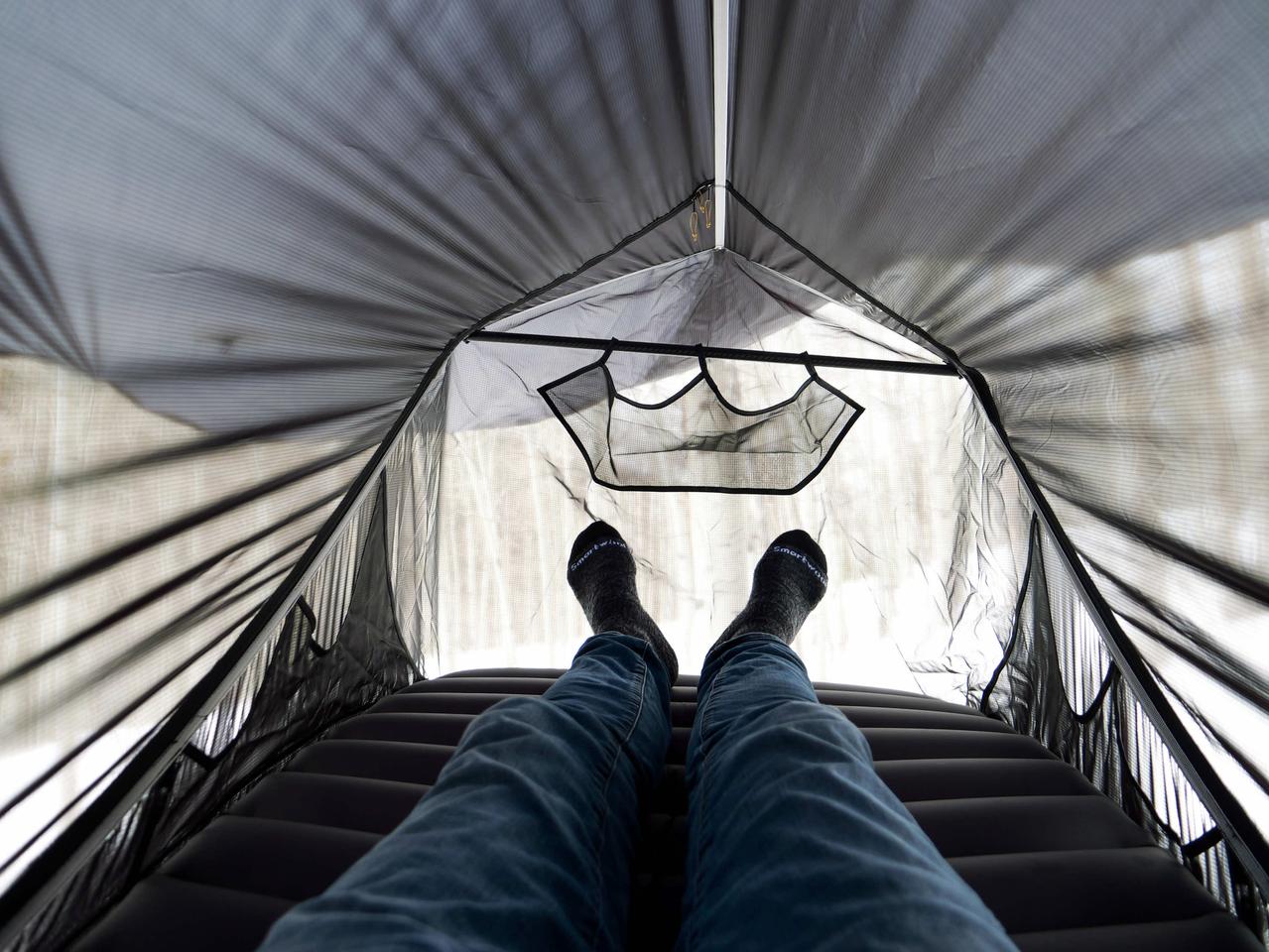 The mesh panels allow users to see their surroundings, although the rainfly can be pulled down for privacy or windproofing as needed