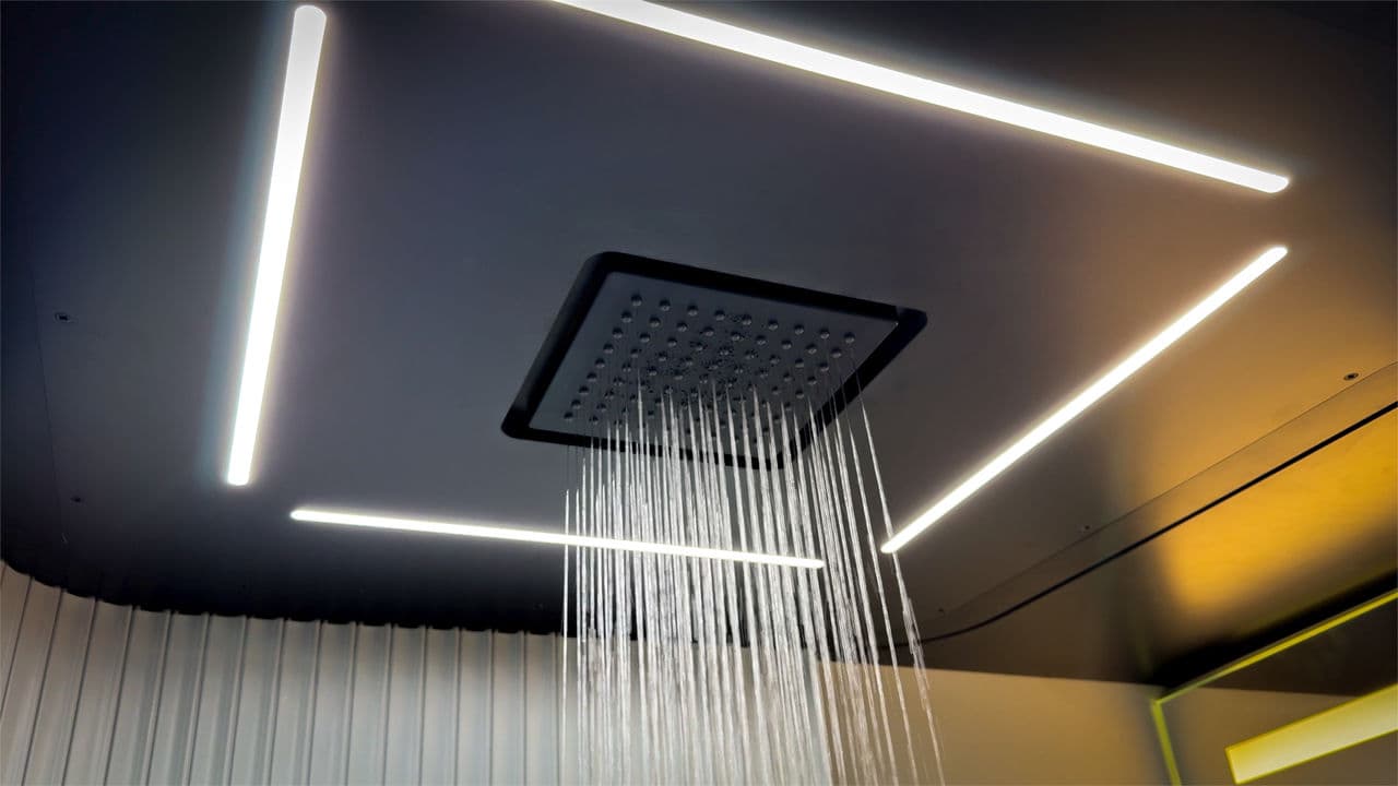 The rainfall shower is located right over the center aisle, which becomes part of the bathroom
