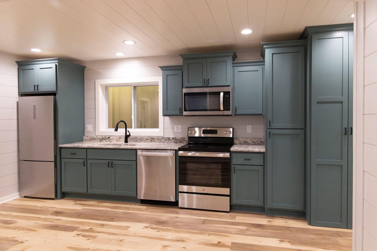 The Double Duo's kitchen is relatively spacious for a container-based house and includes a dishwasher, oven and microwave, and lots of cabinetry