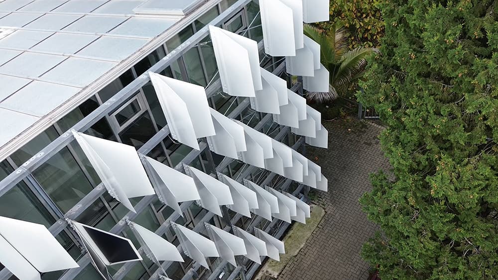 In cooler weather, the flaps fold together to open up the facade