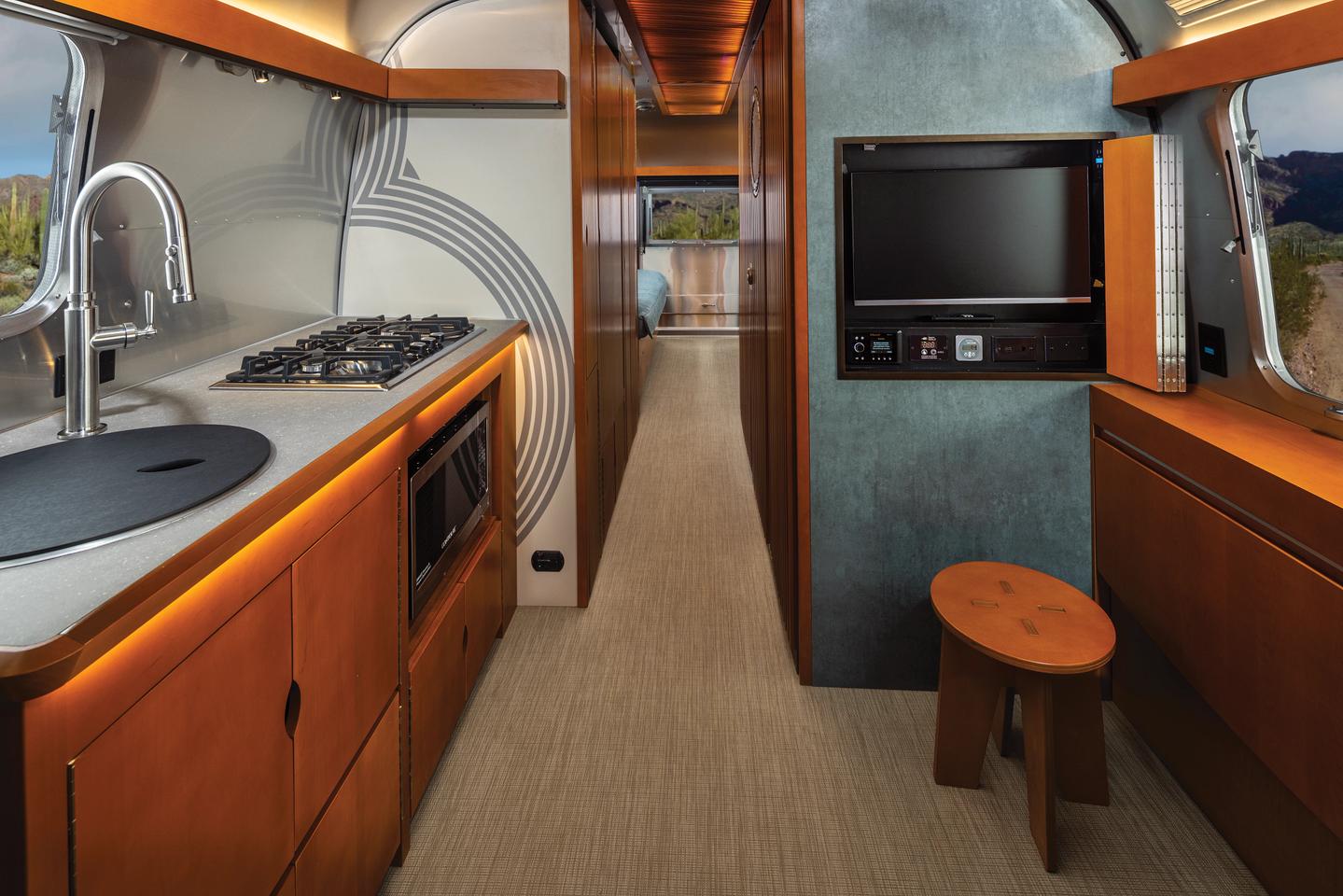 The Airstream kitchen and front dining/lounge area, complete with wall-integrated TV