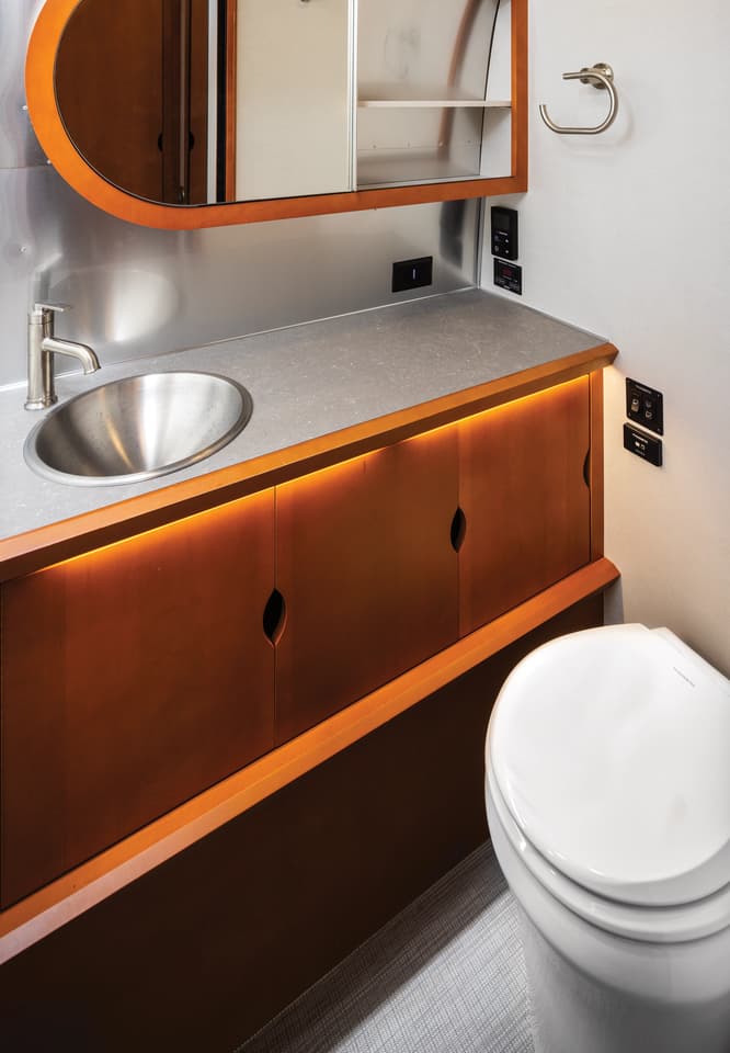 The dry bathroom features a generously sized toilet room with sink, mirror and counter