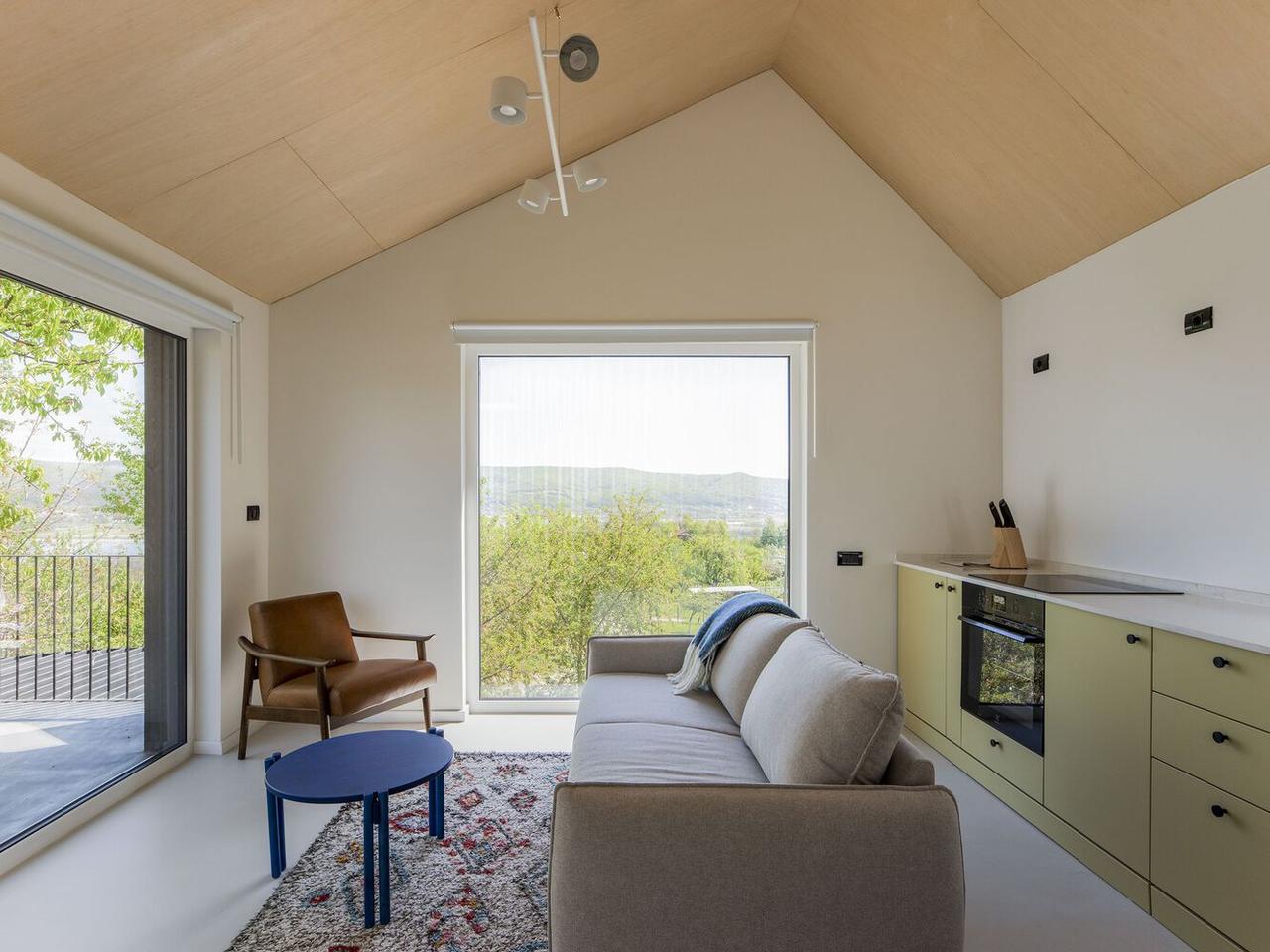 A vaulted ceiling and panoramic forest views give the CL02 Cabin a sense of expansiveness despite its size